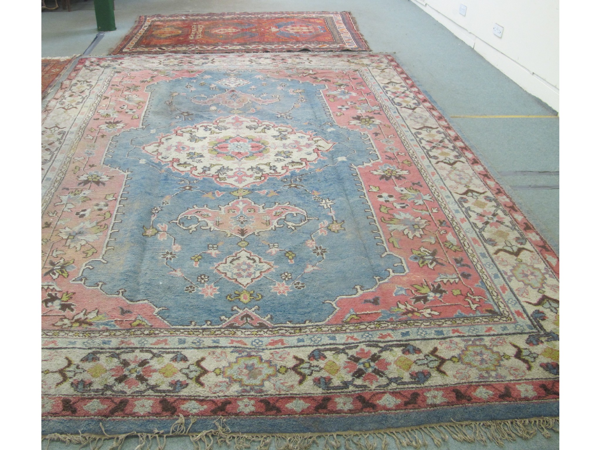 Appraisal: Persian floral decorated carpet on a pink and blue ground