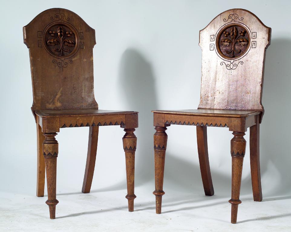 Appraisal: PAIR OF VICTORIAN OAK HALL CHAIRS each with arched back