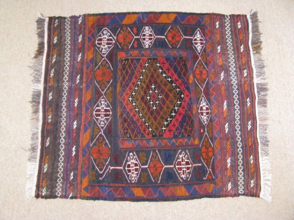 Appraisal: Afghanistan hand knotted wool carpet with reds blacks and blues