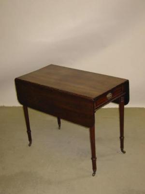 Appraisal: A MAHOGANY PEMBROKE TABLE of rounded oblong form with frieze