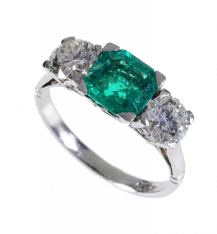 Appraisal: AN EMERALD AND DIAMOND THREE STONE RING the step cut