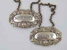 Appraisal: A pair of Georgian silver wine labels pierced '' Sherry