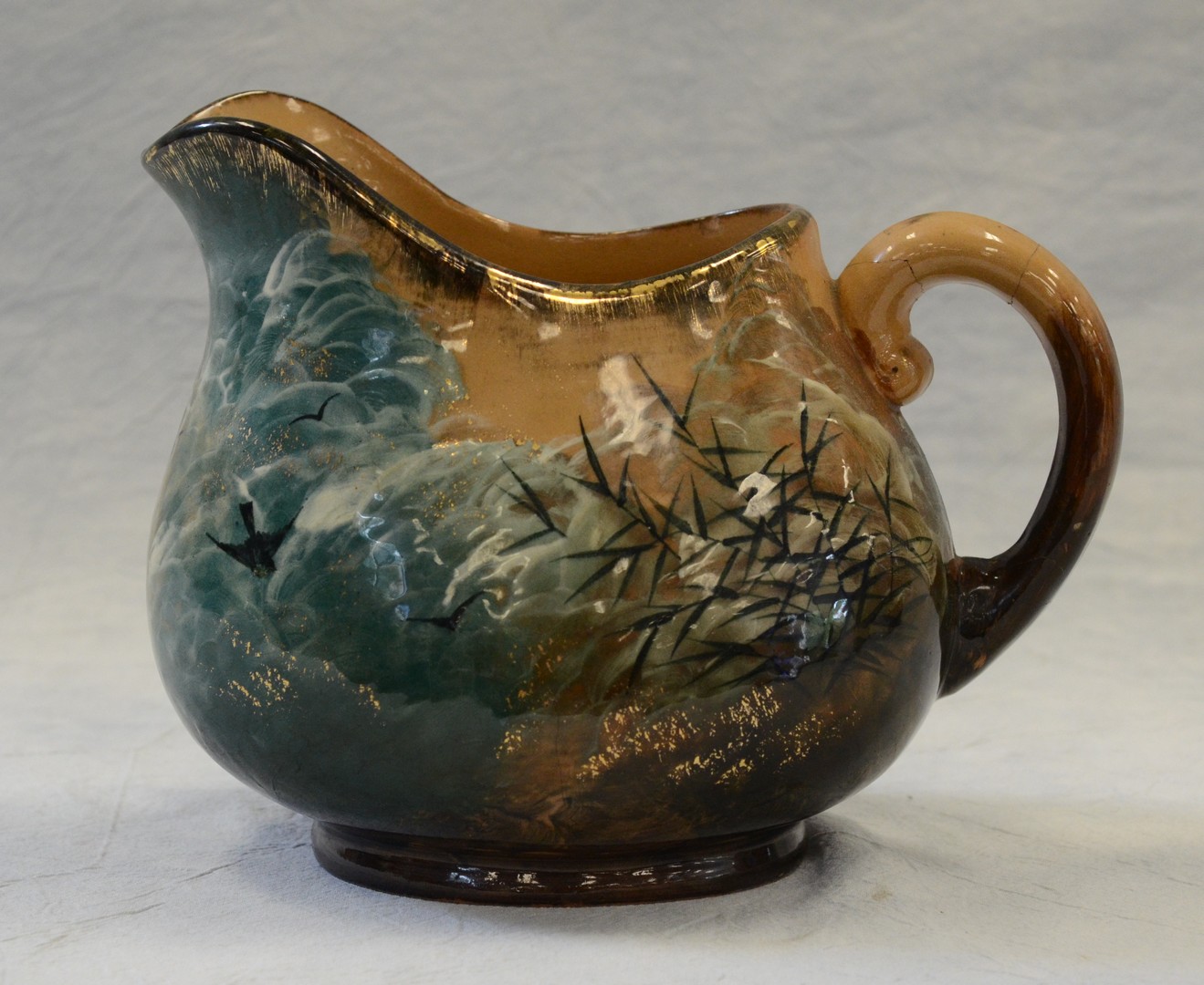 Appraisal: Rookwood Pottery pitcher birds on branches design high glaze by