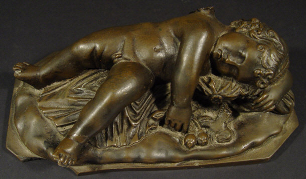 Appraisal: Cast metal figure of a sleeping cherub on a day