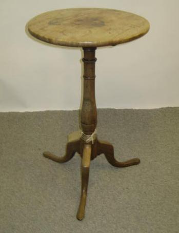 Appraisal: A MAHOGANY WINE TABLE the circular top on turned baluster