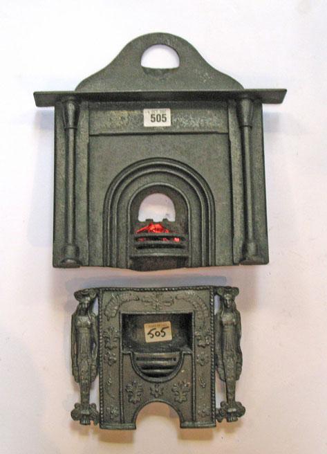 Appraisal: A CAST IRON MINIATURE FIREPLACE with hob grate decorated overall