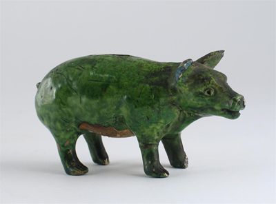 Appraisal: A green glazed pottery moneybox formed as a pig Damages