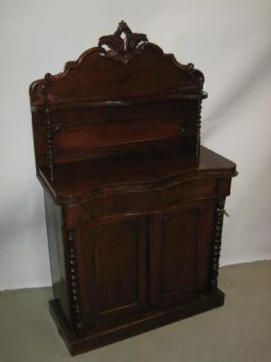 Appraisal: A VICTORIAN WALNUT CREDENZA the arched panelled back with scroll