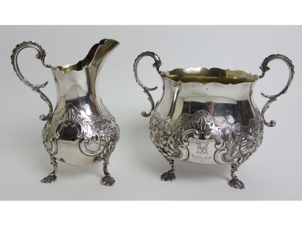 Appraisal: A matched silver cream and sugar embossed with floral decoration