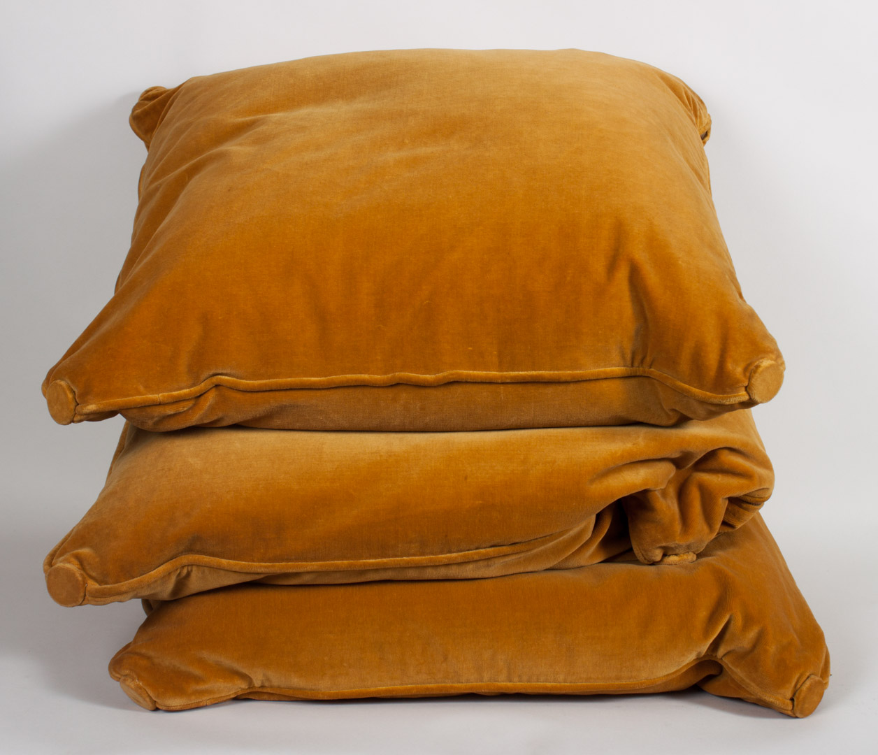 Appraisal: Three gold velvet decorator pillows