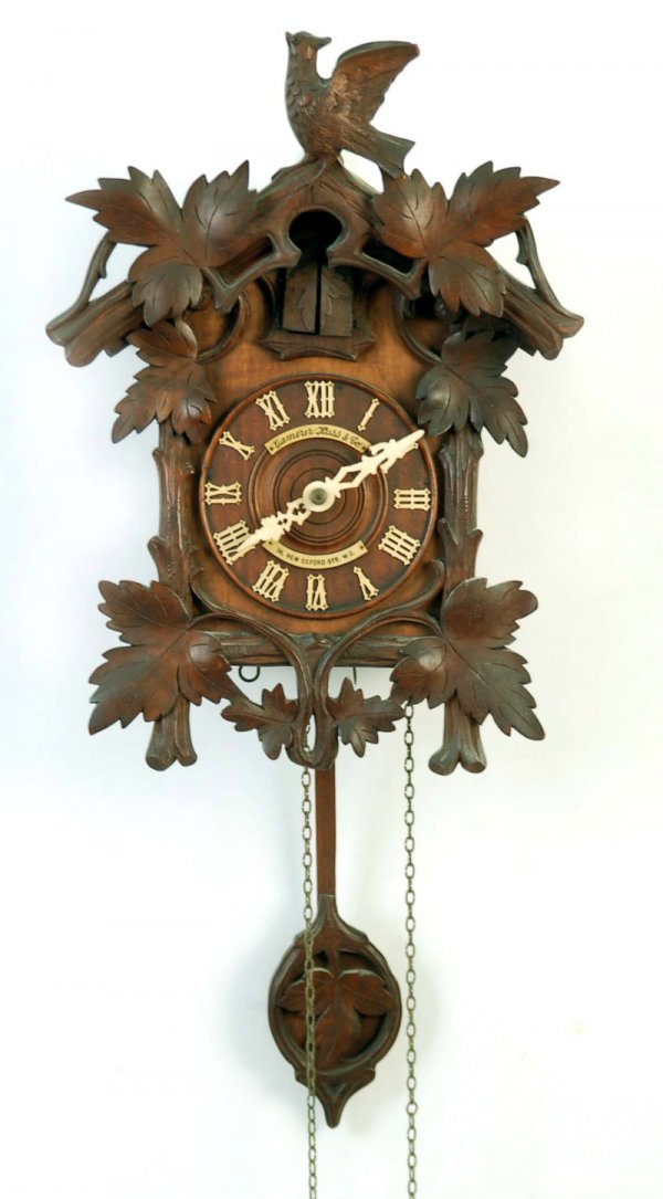 Appraisal: Ornately carved black forest hanging clock with cuckoo that appears