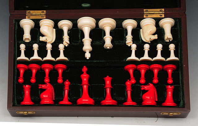 Appraisal: A STAINED BOXWOOD CHESS SET in a velvet lined wooden