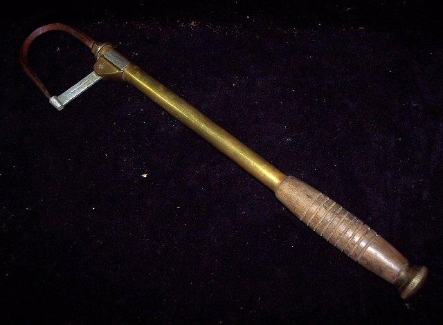 Appraisal: A brass extending gaff with turned wood handle