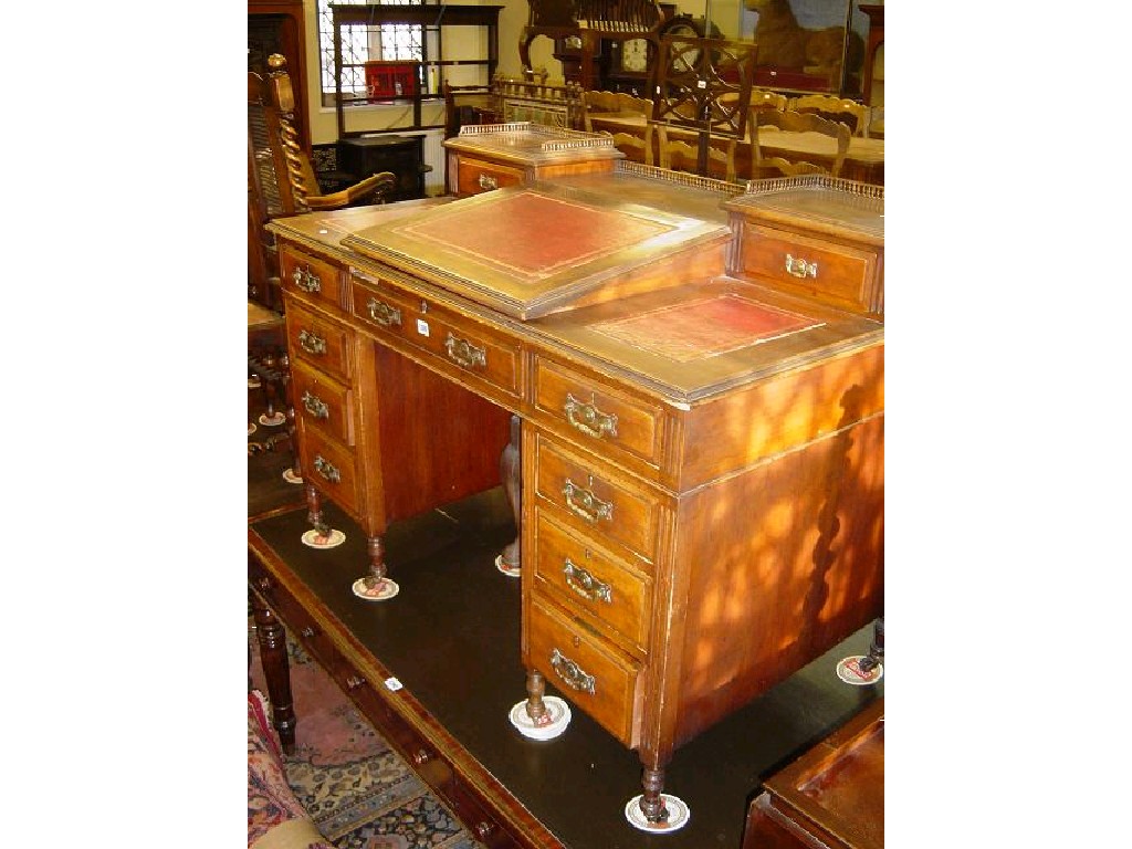 Appraisal: An Edwardian walnut desk with raised upper section with writing