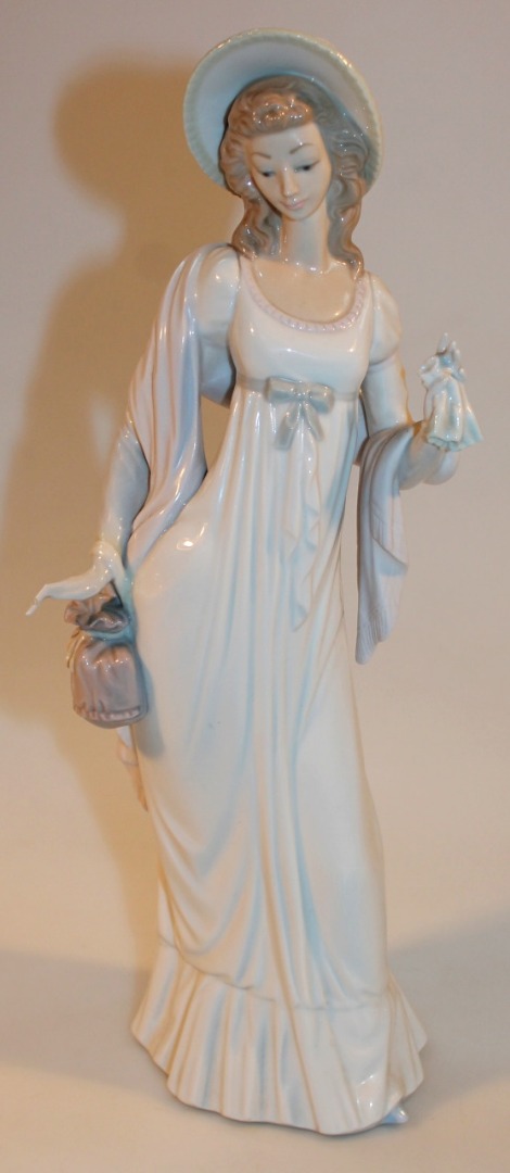 Appraisal: A thC Lladro figure of a lady holding a bag