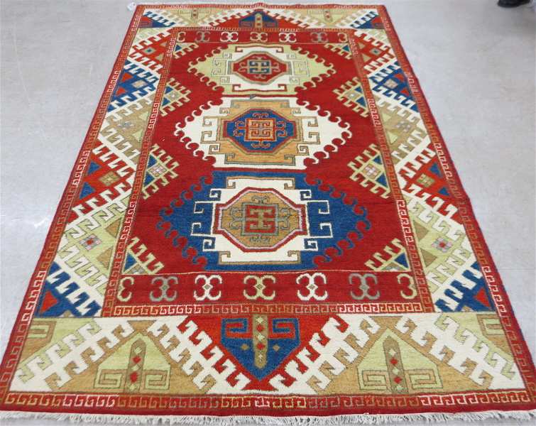 Appraisal: HAND KNOTTED ORIENTAL CARPET Indo-Kazak triple geometric medallion design on