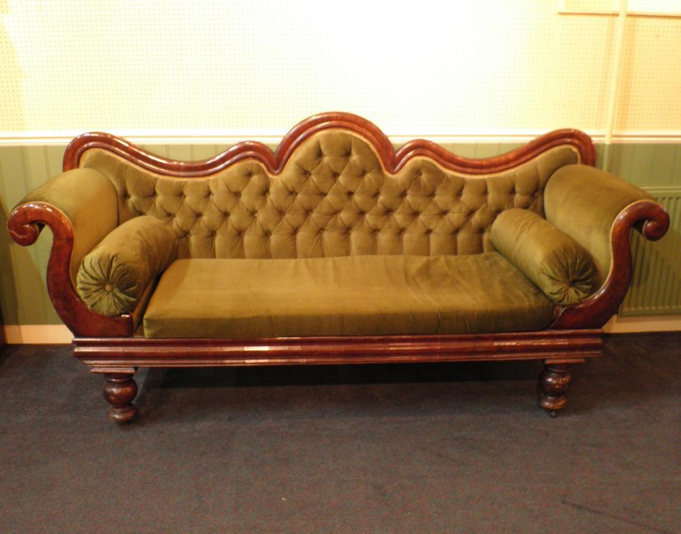 Appraisal: A Victorian mahogany show frame sofa with a shaped back