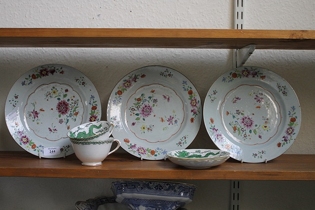 Appraisal: THREE CHINESE FAMILLE ROSE PLATES a green dragon tea set