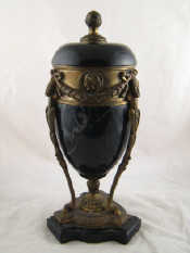 Appraisal: A statuary dark green marble urn and cover in bronze