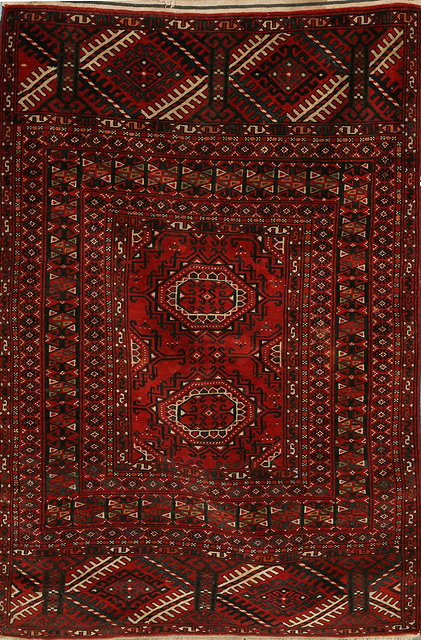 Appraisal: A PERSIAN YOMUT WINE GROUND RUG with twin central medallions