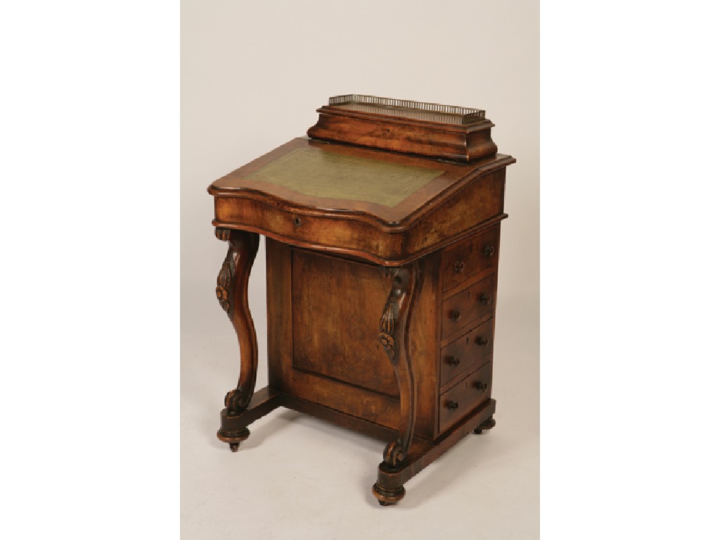 Appraisal: A VICTORIAN WALNUT VENEERED DAVENPORT with a raised stationery compartment