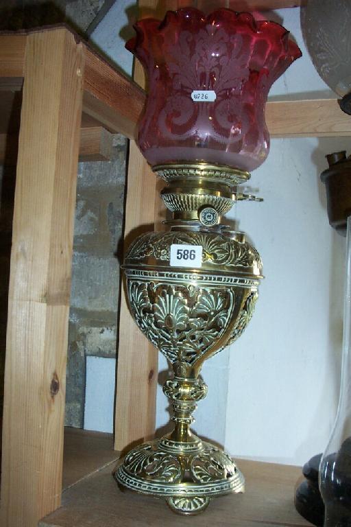 Appraisal: A Victorian brass oil lamp with cast and pierced panels