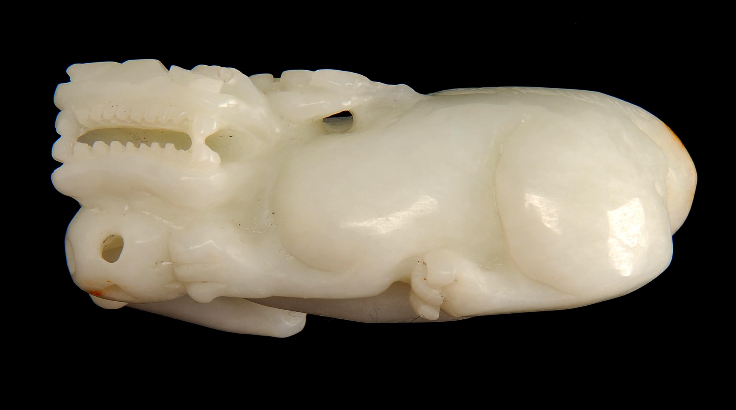 Appraisal: WHITE JADE FIGURE OF A LION In a crouched position