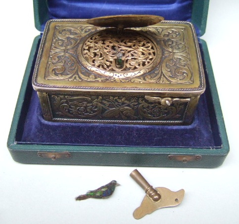 Appraisal: A gilt rectangular cased key wind musical box the case