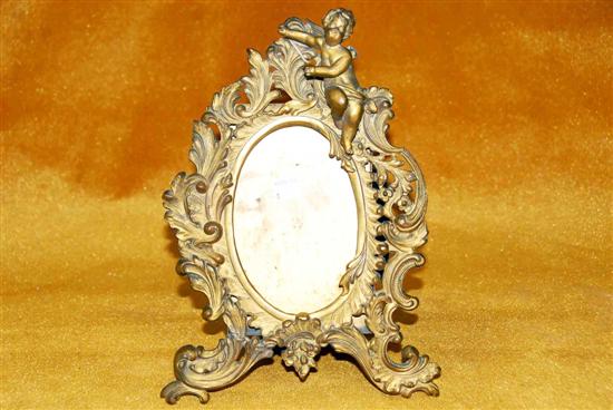 Appraisal: BRASS FRAME WITH PUTTI H losses From a fine th