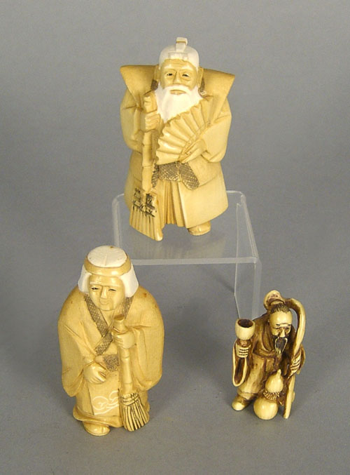 Appraisal: Two carved ivory figures together with a netsuke