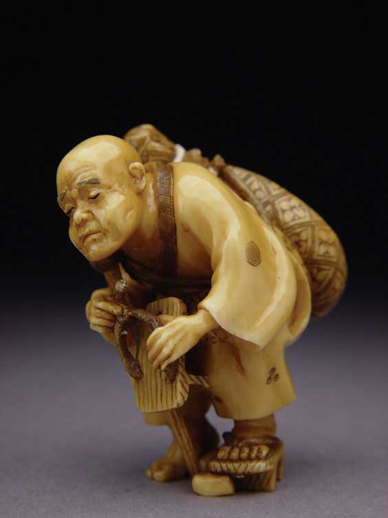 Appraisal: CARVED IVORY NETSUKE Well carved and stained contemporary ivory netsuke