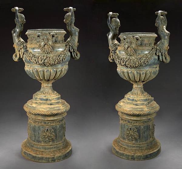 Appraisal: A pair of Neoclassical style patinated bronze urns on pedestals