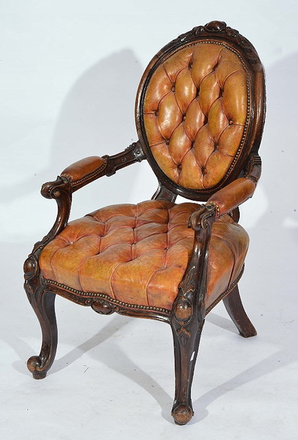 Appraisal: A VICTORIAN OAK LIBRARY ARMCHAIR with carved cresting rail and