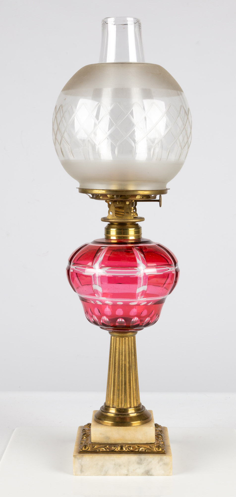 Appraisal: CRANBERRY OVERLAY OIL LAMP circa cranberry cut to clear geometric