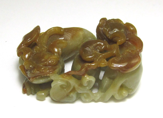 Appraisal: CHINESE CARVED JADE SCULPTURE multi-color jade carving of a pair