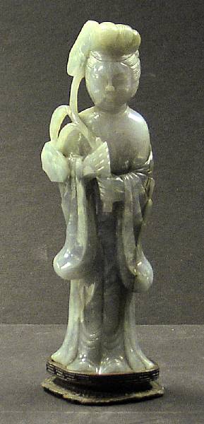 Appraisal: A mottled pale green jadeite figure of a beauty russet