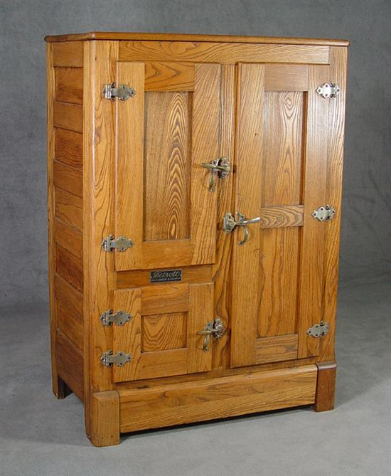 Appraisal: Oak Icebox Early th Century Three doors open to zinc-lined