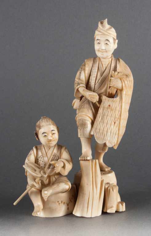 Appraisal: Japanese carved ivory figural group of a farmer and young