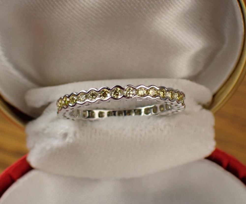 Appraisal: YELLOW DIAMOND AND FOURTEEN KARAT GOLD ETERNITY BAND The k