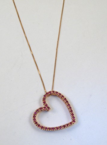 Appraisal: RUBY PENDANT NECKLACE the heart shaped pendant is suspended on