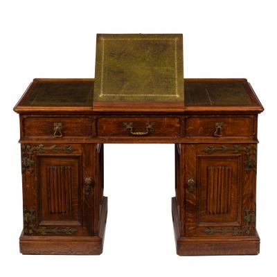 Appraisal: A Gothic revival oak desk with linen fold decoration to