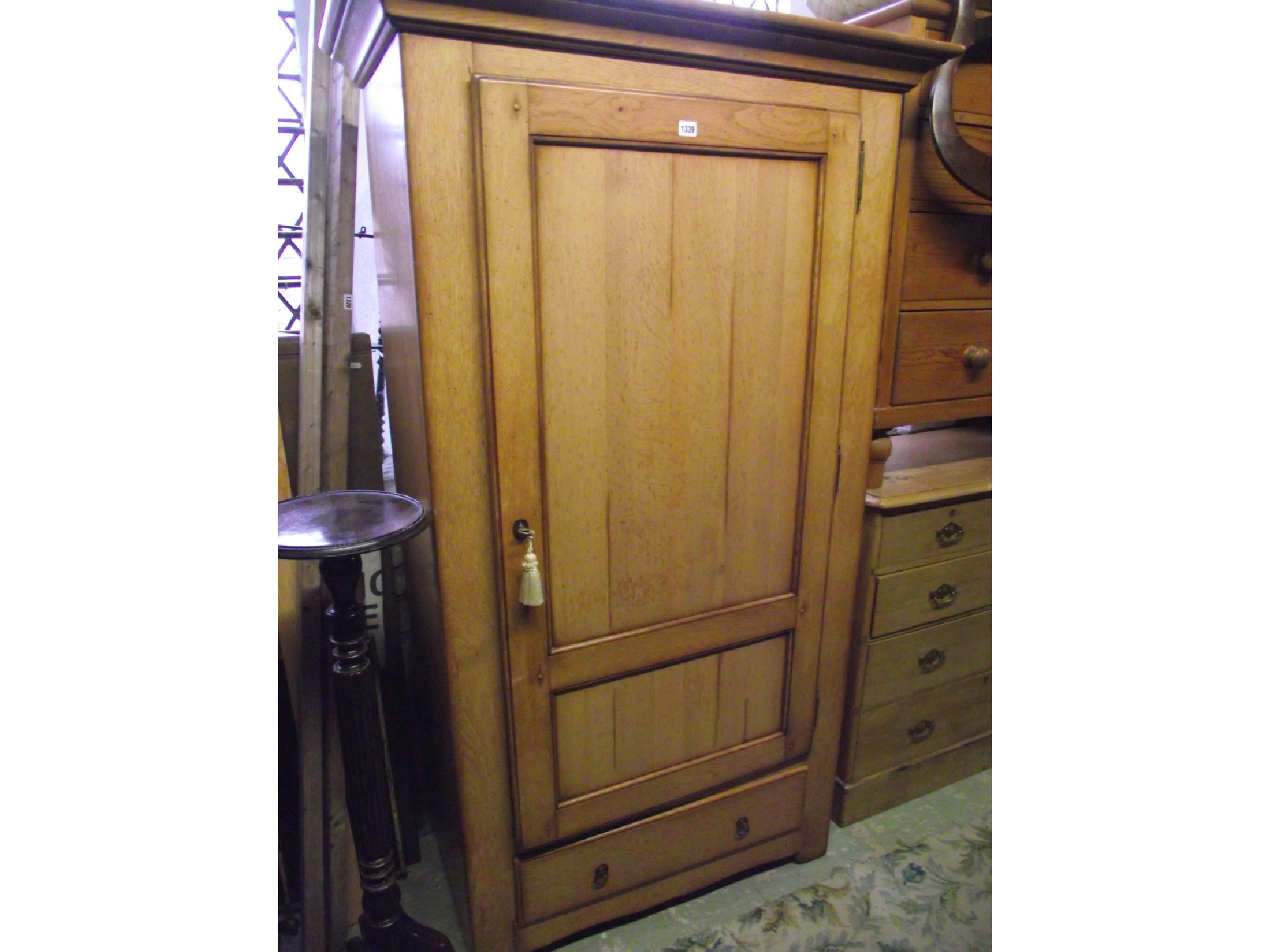 Appraisal: A contemporary reproduction oak armoire side cupboard enclosed by a