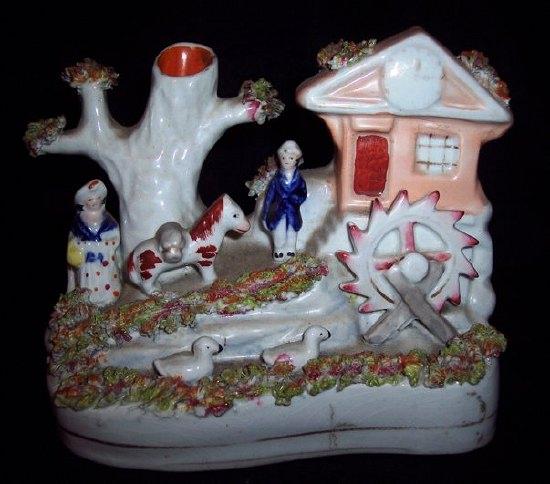 Appraisal: A Staffordshire pastille burner a watermill with tree beside male