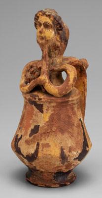 Appraisal: Earthenware mask jug figure holding a mask in front of