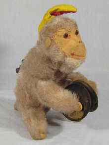 Appraisal: A mechanical monkey toy playing cymbals and leaping along Ht