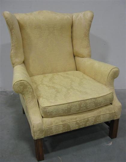 Appraisal: Cherry yellow upholstered wing chair with carved square legs and