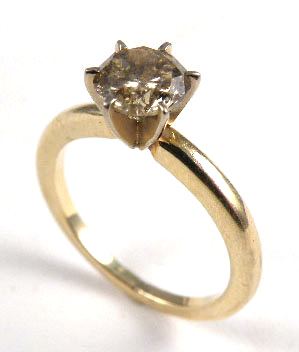 Appraisal: DIAMOND AND FOURTEEN KARAT GOLD RING centering a round brilliant-cut