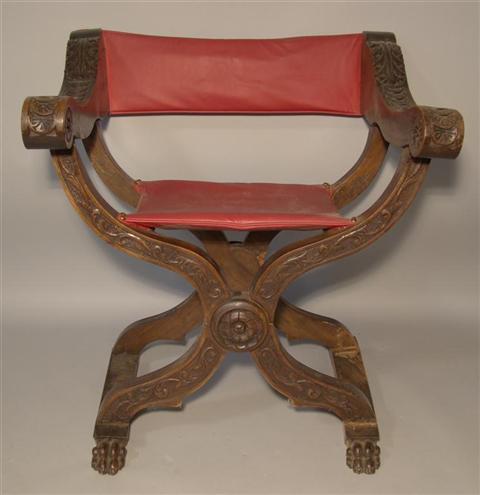 Appraisal: RENAISSANCE REVIVAL X-FRAME ARMCHAIR with acanthus leaf carvings and red