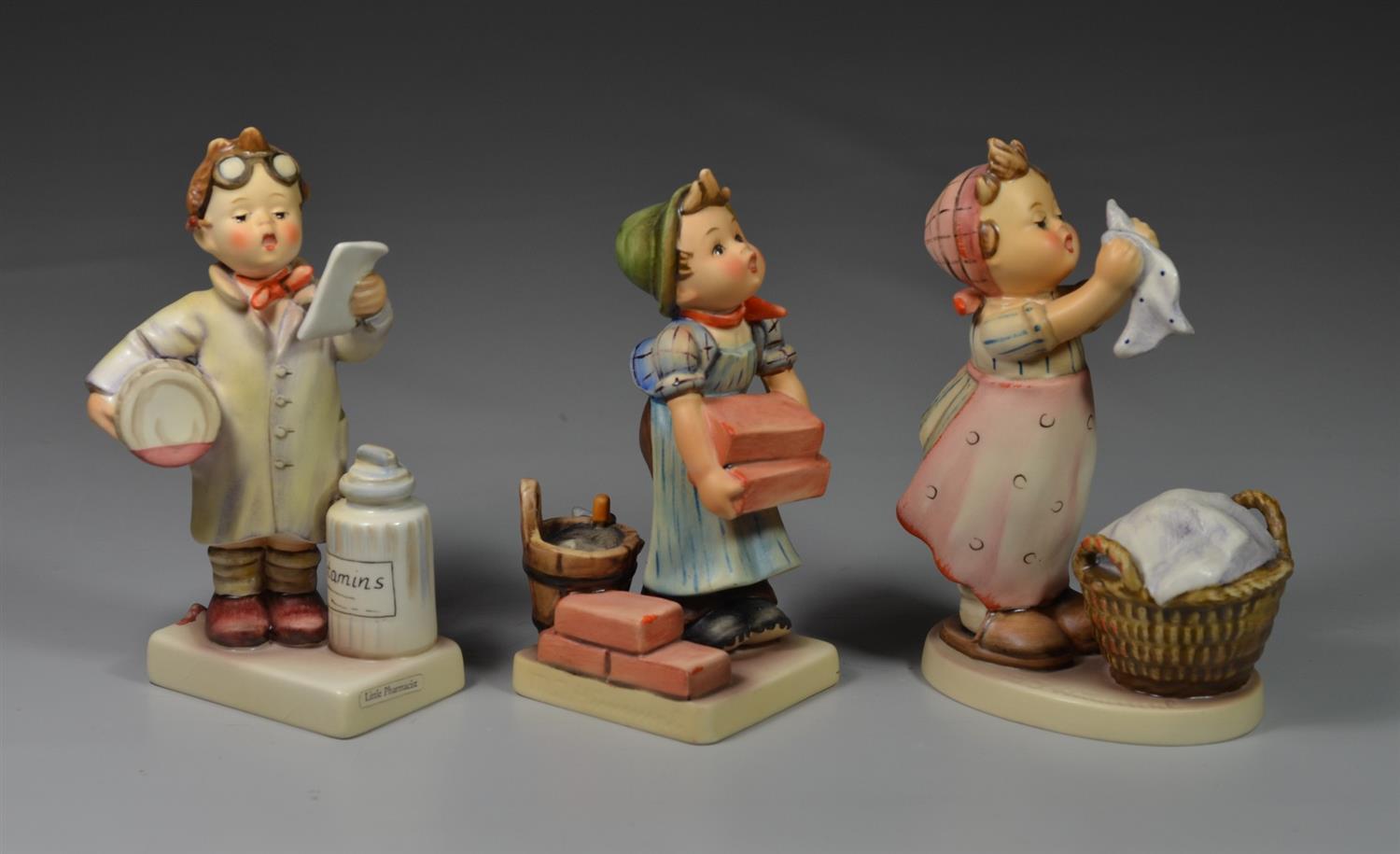 Appraisal: Goebel Hummel Figurines Little Pharmacist crazing The Builder Wash Day