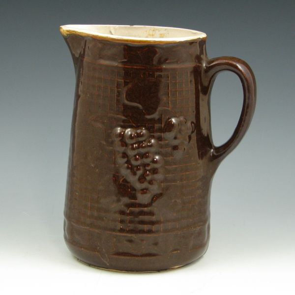 Appraisal: Brown glazed stoneware pitcher with grapes and leaves Unmarked Two